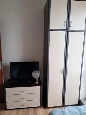 a bedroom with a bed and a dresser with a tv at Apartament in Aheloy in Aheloy