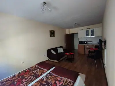a bedroom with a bed and a living room at Studio Zora in Burgas City