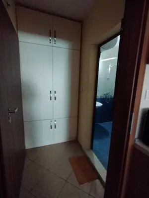 a bathroom with white cabinets and a mirror at Studio Zora in Burgas City