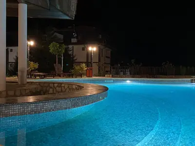 a large swimming pool at night at Etara 2 Apartment in Sveti Vlas