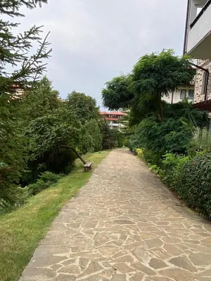 a stone path with trees on the side of a building at Etara 2 Apartment in Sveti Vlas
