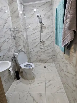 a bathroom with a shower and a toilet and a sink at Релакс в Равда! in Ravda