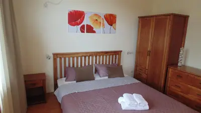 a bedroom with a bed with two towels on it at Garden of Eden in Sveti Vlas