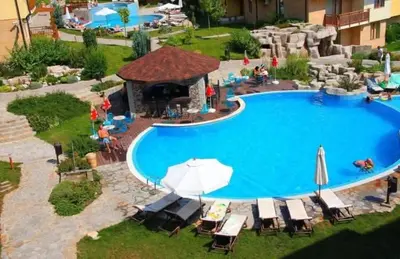 an overhead view of a swimming pool with chairs and umbrellas at Garden of Eden in Sveti Vlas