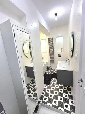 a bathroom with a black and white checkered floor at Seaside Apartment in Varna City