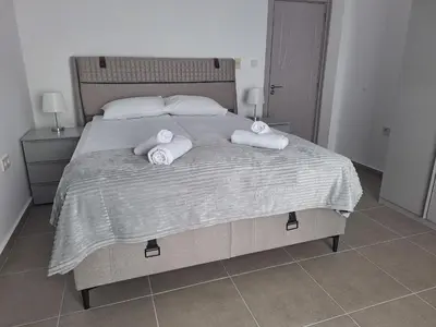 a bedroom with a large bed with towels on it at Sun Coast by the Sea in Sveti Vlas