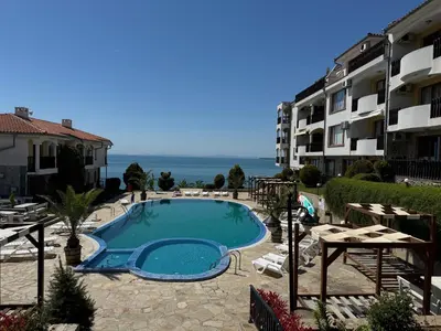 a swimming pool in front of a building at Sun Coast by the Sea in Sveti Vlas