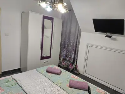a bedroom with a bed with two pillows on it at Pomponi in Burgas City
