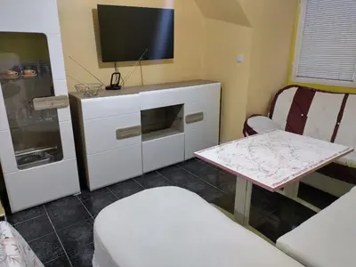 a living room with a tv and a table at Pomponi in Burgas City