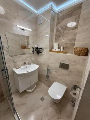 a bathroom with a white sink and a toilet at Апартаменти Sozopol Residence in Sozopol