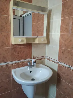 a bathroom with a sink and a mirror at Къща за гости Ками in Byala