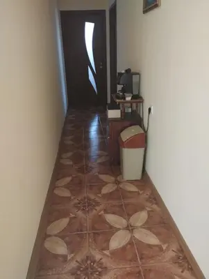 a hallway with a tiled floor and a door at Къща за гости Ками in Byala