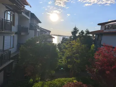 a view of the water from between two buildings at Lavender Apartment in Sozopol