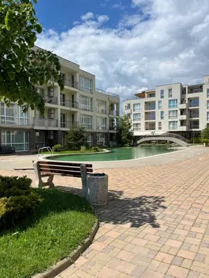 a park bench sitting in front of a building at Casa del Sol in Sunny Beach