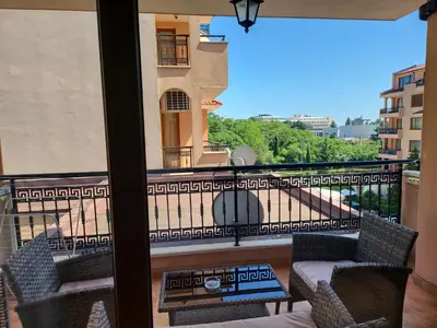 a balcony with chairs and a view of a building at Efir Sunny beach holiday apartment in Sunny Beach