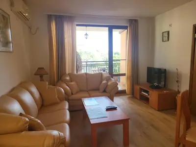 a living room with a couch and a table at Efir Sunny beach holiday apartment in Sunny Beach