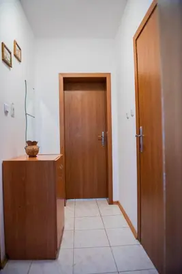 a hallway with a wooden door and a table at 
