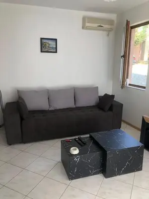 a living room with a brown couch and a table at 
