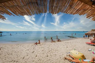 a group of people on a beach with the ocean at Private Apartment 171 in Prestige Fort Beach Hotel in Sveti Vlas