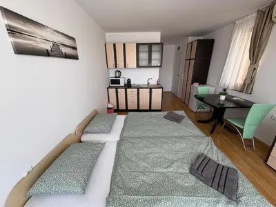 a room with a bed and a dining room at Private Apartment 171 in Prestige Fort Beach Hotel in Sveti Vlas