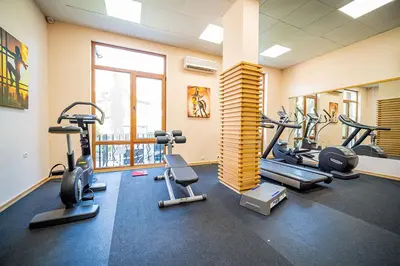 a gym with several tread machines in a room at Private Apartment 171 in Prestige Fort Beach Hotel in Sveti Vlas