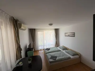 a small bedroom with a bed and a table at Private Apartment 171 in Prestige Fort Beach Hotel in Sveti Vlas