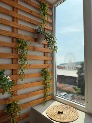 a wooden wall with plants on it next to a window at Smile Old City Apartment with Free parking and Sea view in Varna City