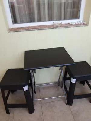 a black table and two chairs in front of a window at Kasndra in Byala