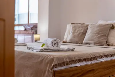 a bed with a towel on top of it at Sunny apartment in the center of Varna for 5Guests in Varna City