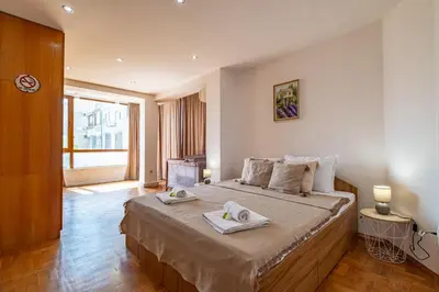 a bedroom with a large bed with two towels on it at Sunny apartment in the center of Varna for 5Guests in Varna City