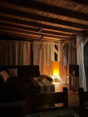 a living room with a couch and a television at Нереида in Sozopol