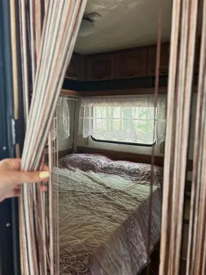 a person is pointing at a bed in an rv at Нереида in Sozopol
