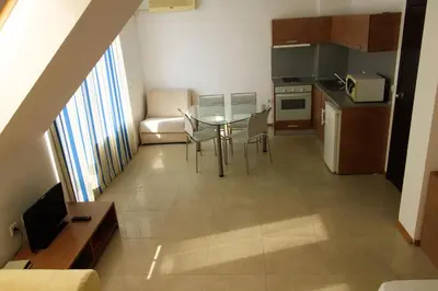 a kitchen with a table and chairs in a room at Belle View - Menada Apartments in Sveti Vlas