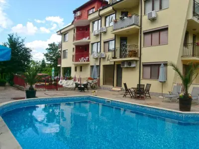 a swimming pool in front of a building at Guest House Granat in Sunny Beach