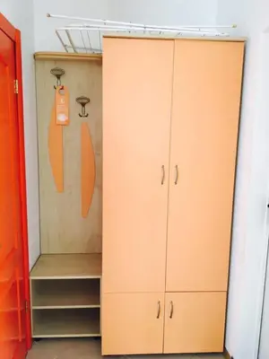 a closet with ajar doors and shelves in a room at Guest House Granat in Sunny Beach