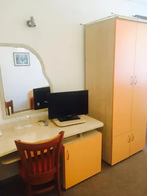 an office with a desk with a computer and a mirror at Guest House Granat in Sunny Beach
