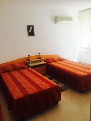 a bedroom with two beds and a sink in it at Guest House Granat in Sunny Beach