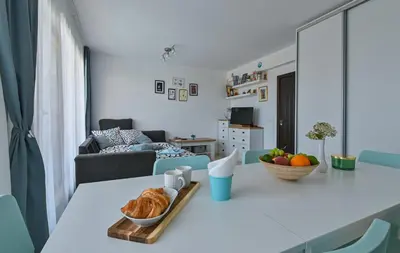 a living room with a table with a bowl of croissants at Via Sunride - Twin Maisonette Apartments by the sea in Sozopol