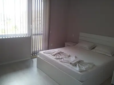 a bedroom with a white bed with towels on it at Apartment Zlatina in Pomorie