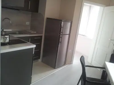 a kitchen with a stainless steel refrigerator in a room at Apartment Zlatina in Pomorie
