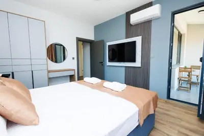 a hotel room with a bed and a tv at Boulevard Hotel in Aytos