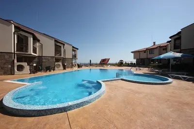 a large swimming pool in the middle of a courtyard at Menada Imperial Heights Apartments in Sunny Beach