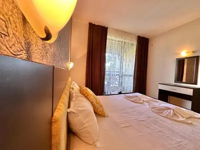 a bedroom with a large bed with a window at Menada Imperial Heights Apartments in Sunny Beach