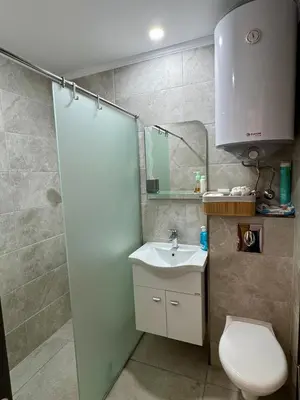 a bathroom with a toilet and a sink and a mirror at Apartment Summer Vibes in Sveti Vlas