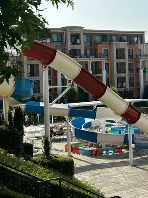 a roller coaster in a park with a water slide at Premier Fort Beach Hotel in Sveti Vlas