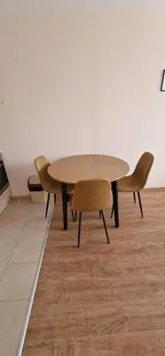 a wooden table and chairs in a room at Premier Fort Beach Hotel in Sveti Vlas