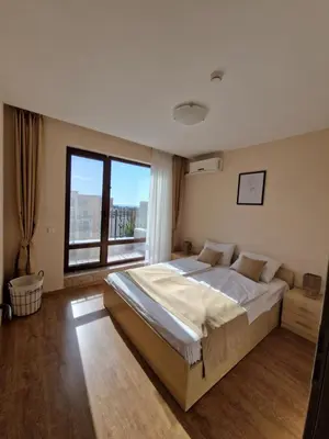 a bedroom with a large bed and a large window at Premier Fort Beach Apartment with Pool & Sea View in Sveti Vlas