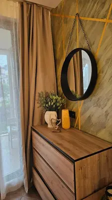 a mirror on top of a wooden dresser in a room at Vladan apartments in Sozopol