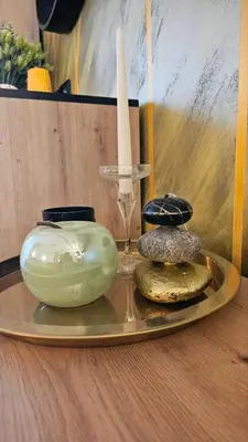 a tray with two vases and a candle on a table at Vladan apartments in Sozopol