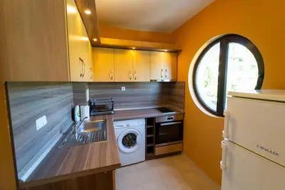 a kitchen with a washer and dryer in it at GGeorgi Sarafovo in Burgas City